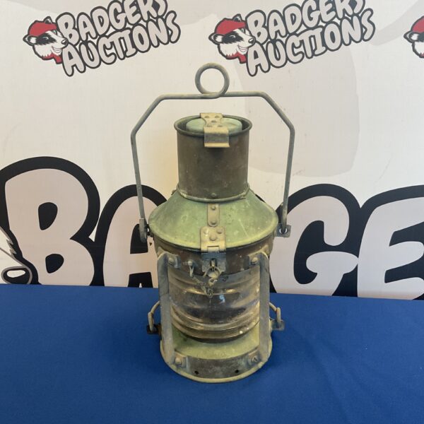 Antique ships oil lantern with brass body and glass enclosure.