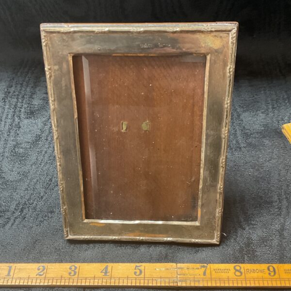 Back of antique silver photo frame with hallmarking details.