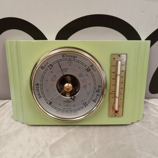 Cream Art Deco barometer with Fahrenheit and Celsius scales.