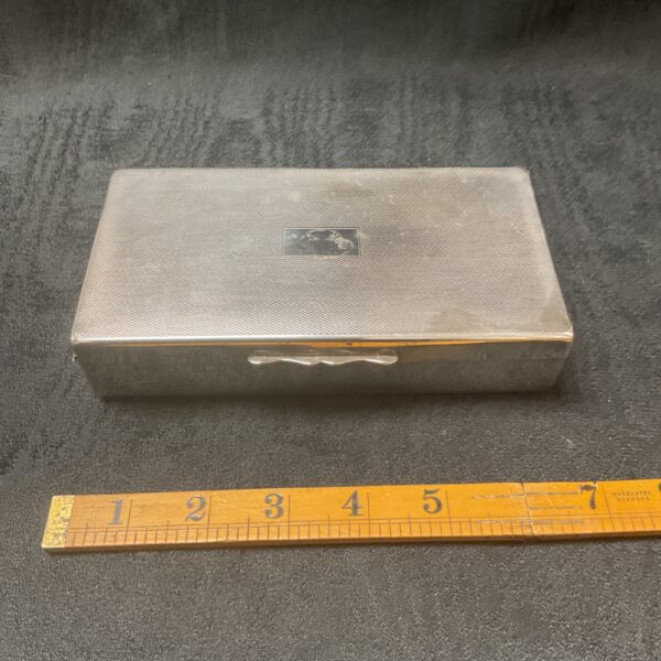 Silver Art Deco cigarette box by Roberts and Dore with engine turning.