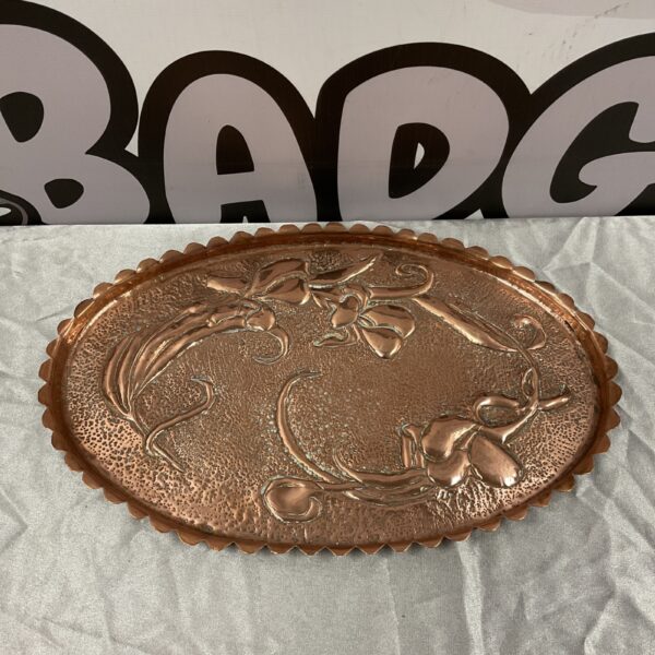 Antique Art Nouveau copper tray with embossed floral design.
