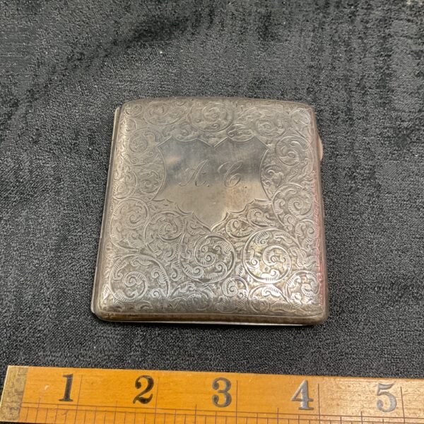 Intricate Art Nouveau sterling silver cigarette case with engraved details.
