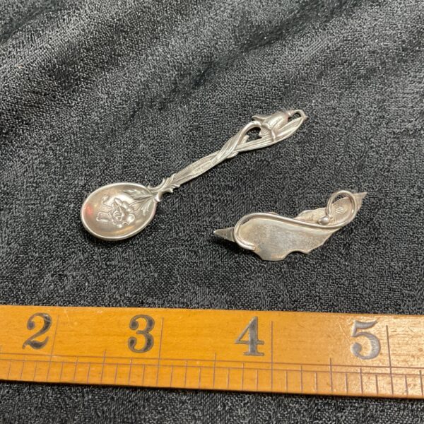 Antique Art Nouveau spoon brooch with floral design.
