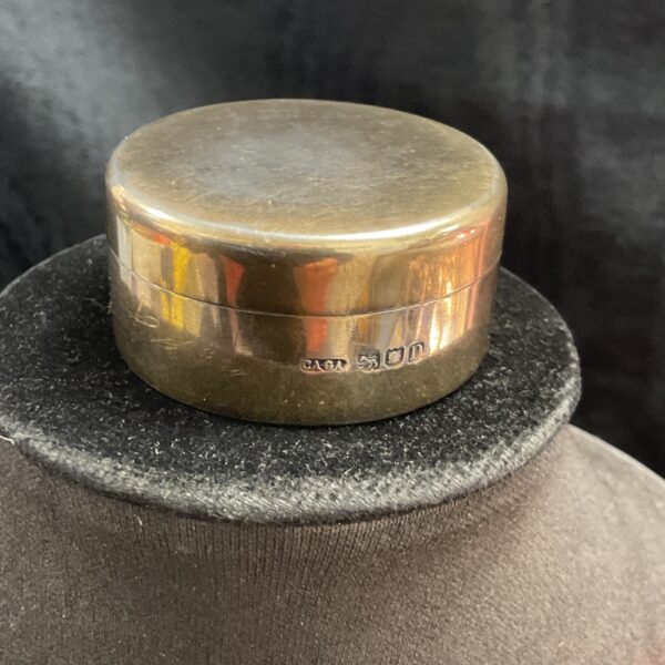 Hallmarked Asprey silver trinket pot on display, antique collectible.