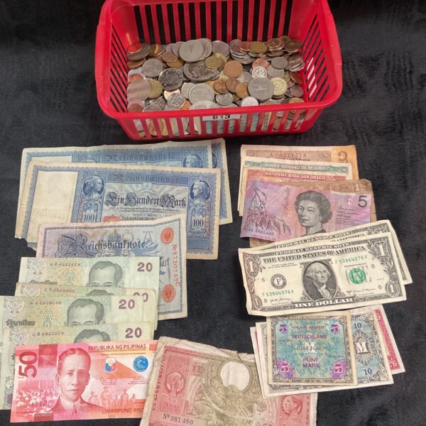 Mixed lot of assorted world banknotes and coins for collectors.