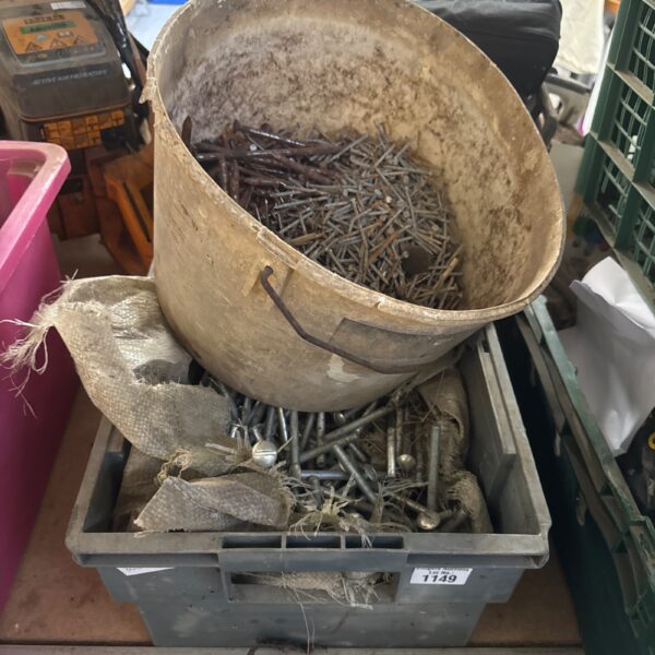 Assorted nails and bolts in tubs, vintage hardware collection.