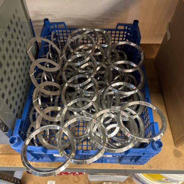 Multiple plastic Audi logos, approximately 12 inches in length.