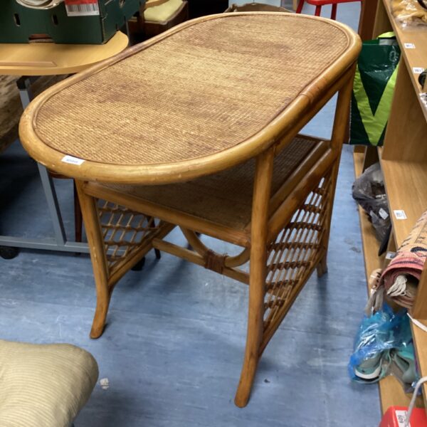 Vintage bamboo conservatory table with woven top and delicate frame.