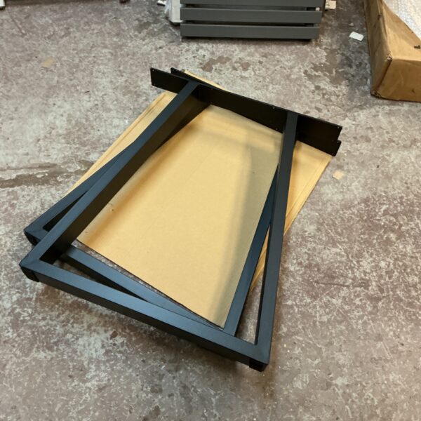 Black metal table legs for furniture, industrial style design.
