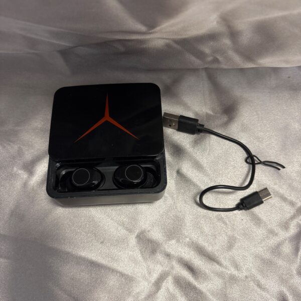 Black wireless headphones in charging case, portable audio device.