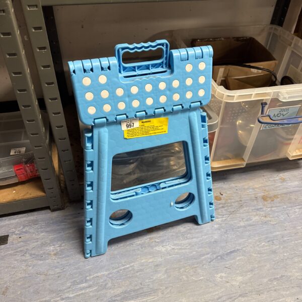 Blue plastic folding step stool for household access.