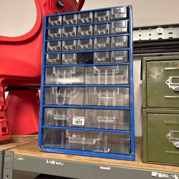 Blue metal organiser cabinet with damaged drawers for workshop storage.