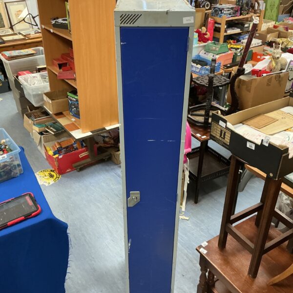 Vintage blue metal storage locker with a grey top.