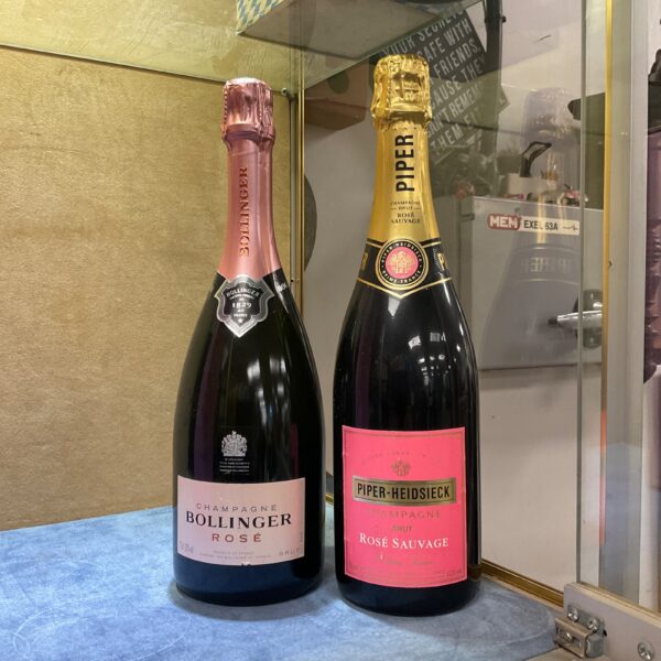Two bottles of rose champagne, Bollinger and Piper Heidsieck.