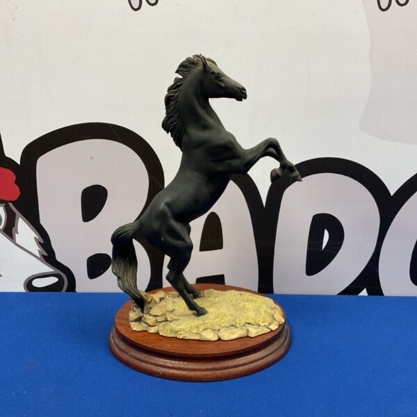 Detailed Border Fine Arts black stallion sculpture by Fred Stone.