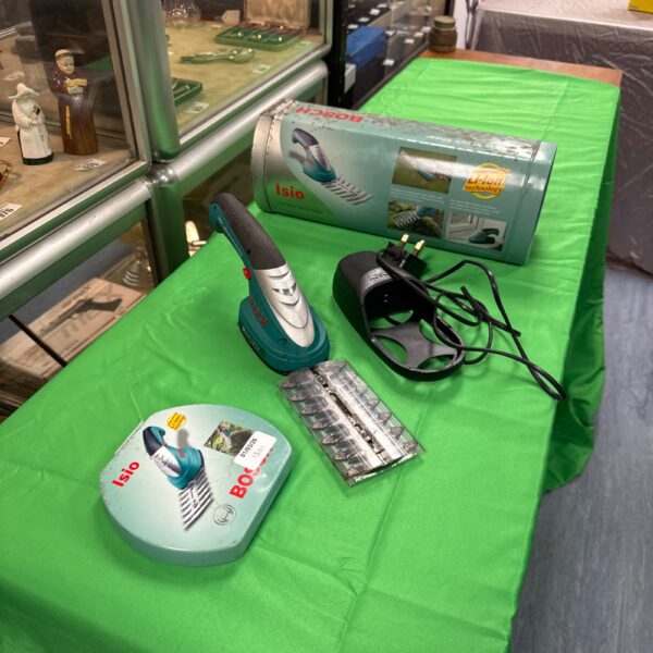 Bosch Isio cordless pruner with charger, garden tool for pruning.