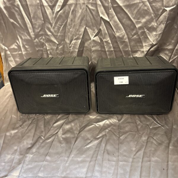 Pair of vintage Bose 101 bookshelf speakers, classic audio equipment.