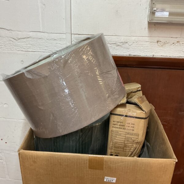 Box of new lampshades for home lighting projects.