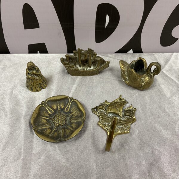Vintage brass collectibles lot including ship, swan, and rose.