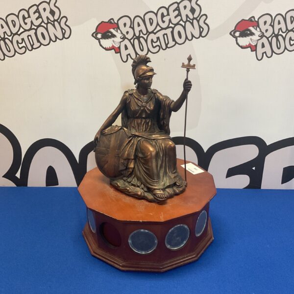 Detailed resin Britannia sculpture with embedded pennies on wooden base.