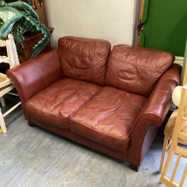 Brown leather two-seater sofa in a vintage style.