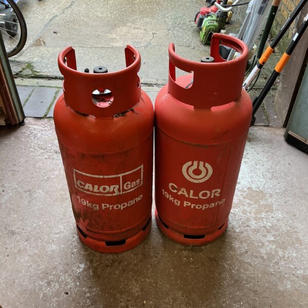 Two used 19kg Calor propane cylinders for outdoor use.