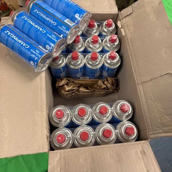 Sealed lot of twenty-four Campingaz butane canisters for camping stoves.