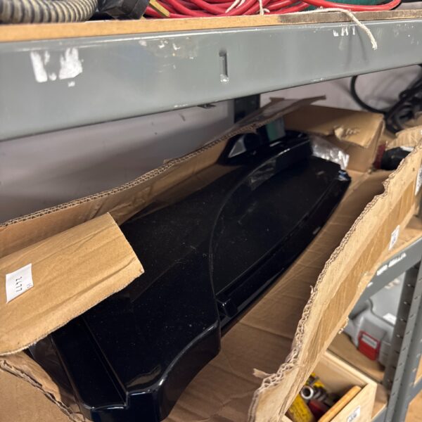 Black car front splitter in cardboard packaging.
