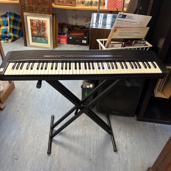 Vintage Casio CPS-7 electric keyboard with folding stand.