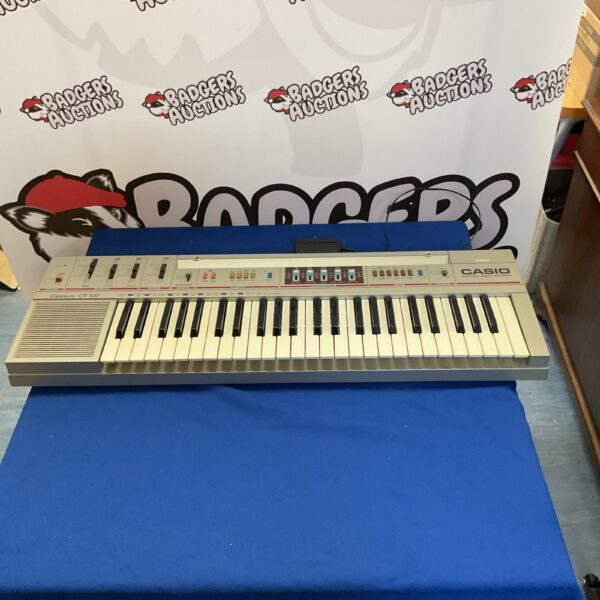 Vintage Casio CT-320 keyboard with keys and controls visible.