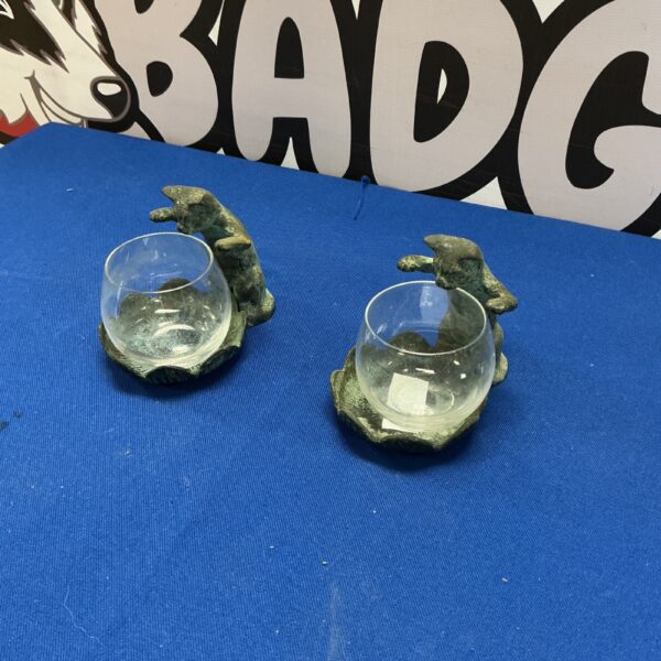 Two cat figurines with glass bowls for home decor.