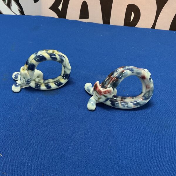 Close-up of handcrafted ceramic cat napkin ring for table decor.