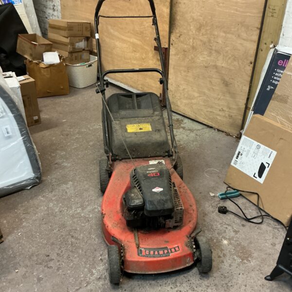 Used Champion 51cm petrol lawnmower for garden maintenance.