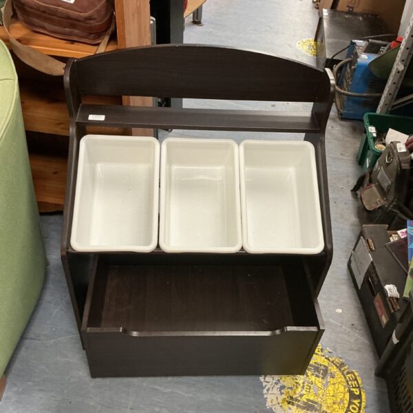 Wooden child’s storage unit with three compartments for toys and books.
