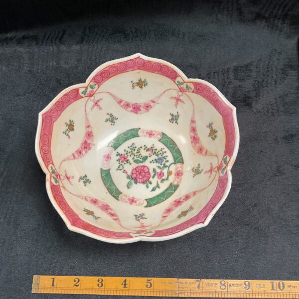 Antique Chinese porcelain bowl with pink floral design.