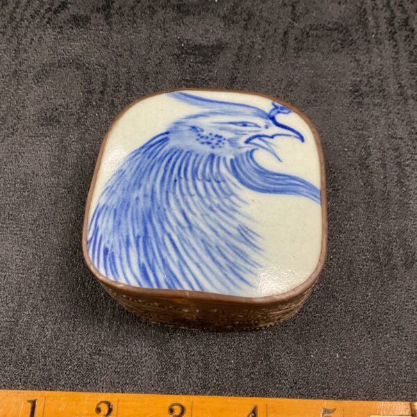 Antique Chinese porcelain box with blue and white bird design.