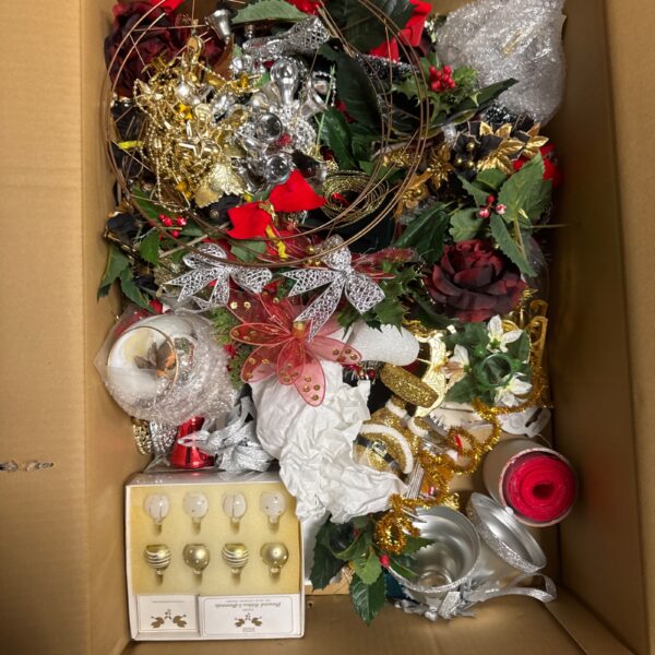 Assorted Christmas decorations including baubles and floral sprays.
