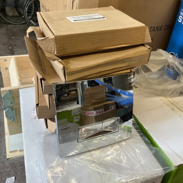Six new chrome toilet flush plates in cardboard packaging.