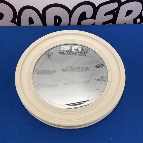 Vintage circular wall mirror with thick frame for home decor.