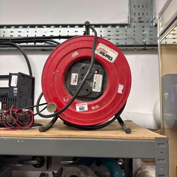 Red Clarke power extension reel for workshop cable storage.