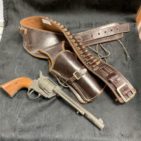 Detailed view of a Colt Single Action Army replica with Western holster.