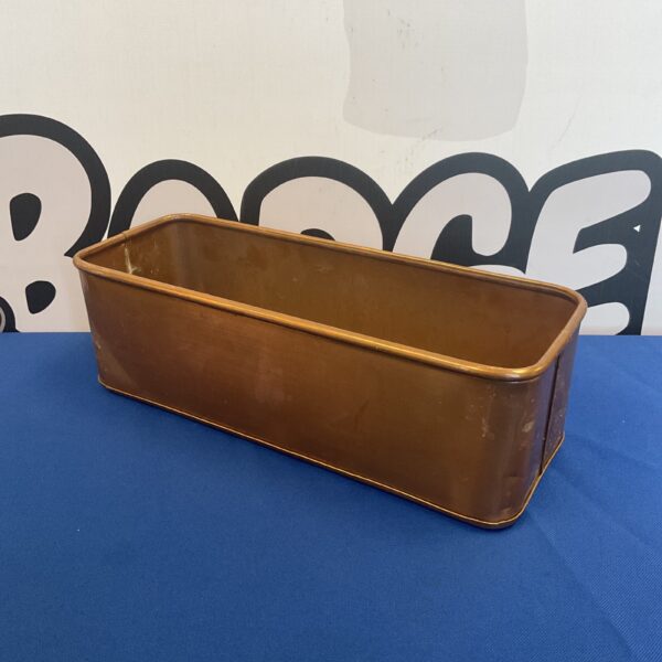 Vintage copper planter trough for garden plants.