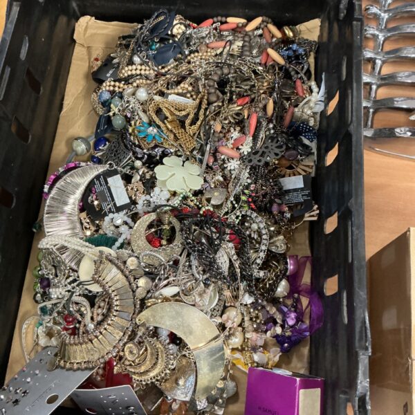 Large assortment of colourful costume jewellery including necklaces and brooches.