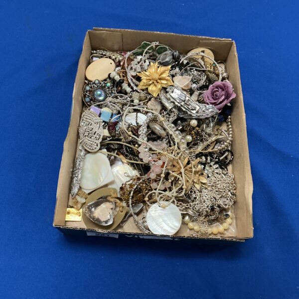 Tray of colourful vintage costume jewellery including brooches and earrings.