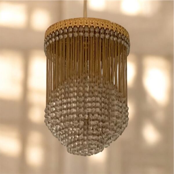 Vintage brass and crystal cascading chandelier for home decor.