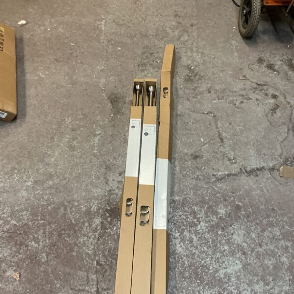 Lot of three brushed metal extendable curtain poles in packaging.