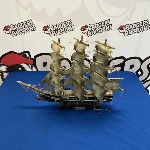 Vintage Cutty Sark model ship with detailed rigging and sails.