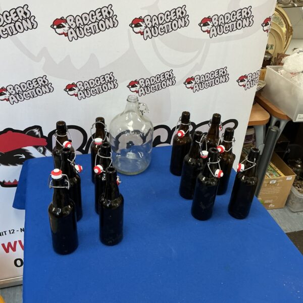 Vintage demijohn and twelve glass beer bottles for collectors.