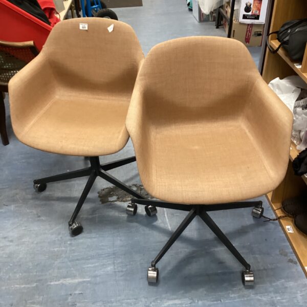 Pair of upholstered designer swivel chairs on casters.