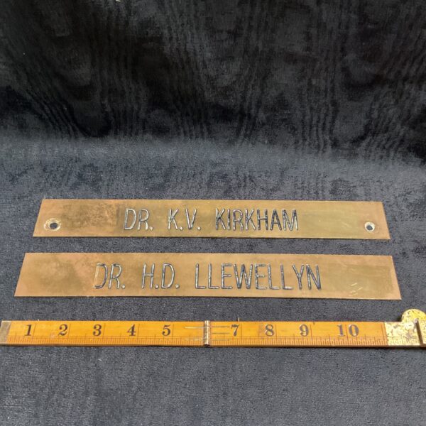 Vintage brass doctor nameplate reading "Dr. Kirkham".